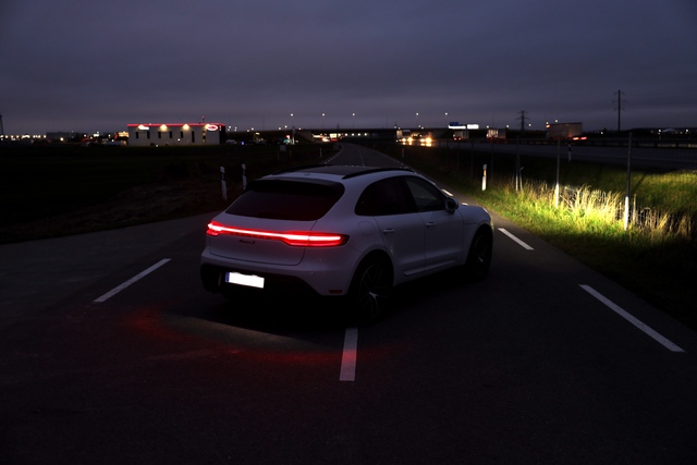 2023-2026 porsche macan s carrera white metallic taillight in the dark road scene